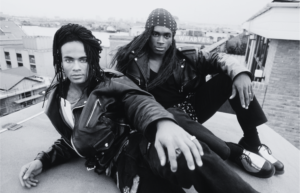 Milli Vanilli performing in the late 1980s, representing scripted and insincere performances used as a metaphor for scripted real estMilli Vanilli lip-sync scandal metaphor representing scripted and insincere relationship marketing in the real estate industryate marketing